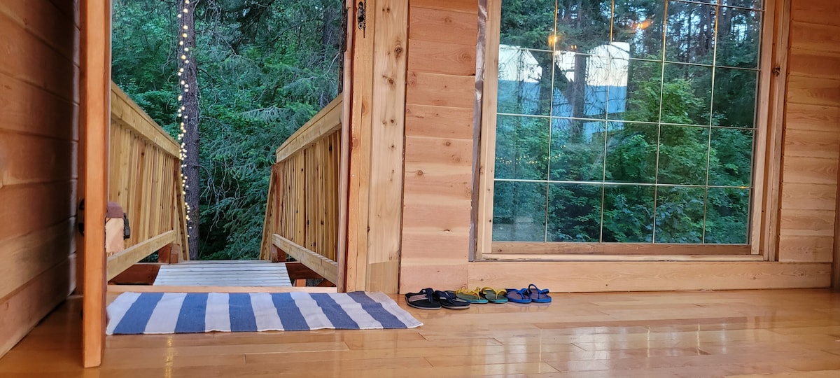 Treehouse doorway and bridge opening into the forest